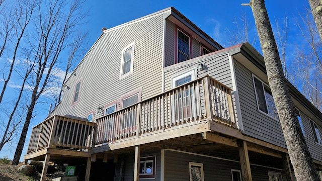 back of house with a deck