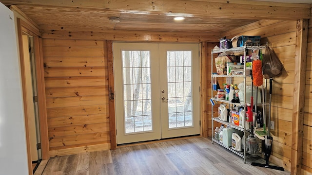 doorway with wood ceiling, wooden walls, and french doors