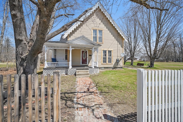 126 Elm St, Newport, ME 04953 - view of front facade featuring fence, covered porch, and a front yard