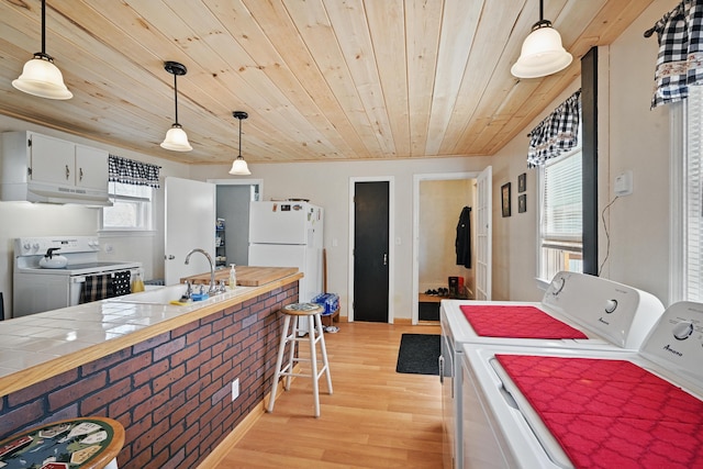 126 Elm St, Newport, ME 04953 - kitchen with wooden ceiling, light wood-style flooring, under cabinet range hood, and white appliances