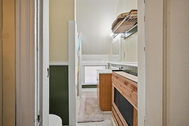 126 Elm St, Newport, ME 04953 - half bathroom with toilet, tile patterned flooring, and vanity