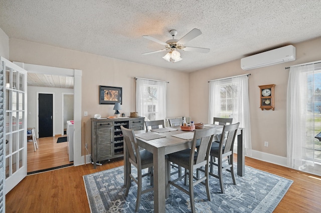 126 Elm St, Newport, ME 04953 - dining space with a wealth of natural light, wood finished floors, a wall unit AC, and a ceiling fan