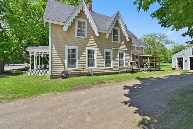 126 Elm St, Newport, ME 04953 - view of front of house with a chimney, a front lawn, and a sunroom