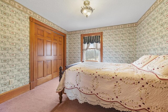 carpeted bedroom featuring baseboards and wallpapered walls