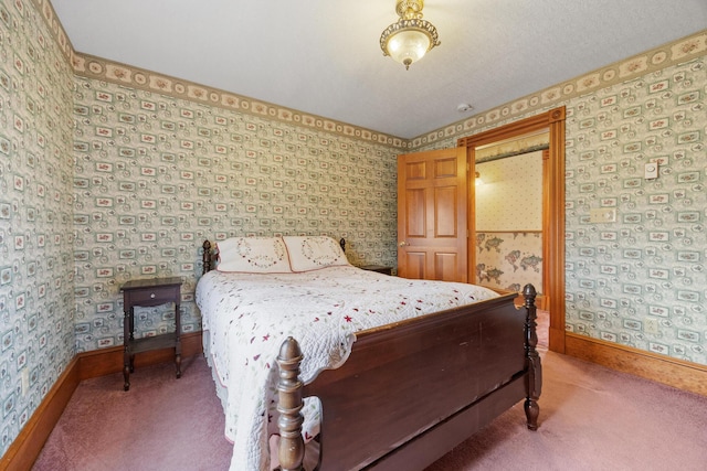 carpeted bedroom with baseboards and wallpapered walls