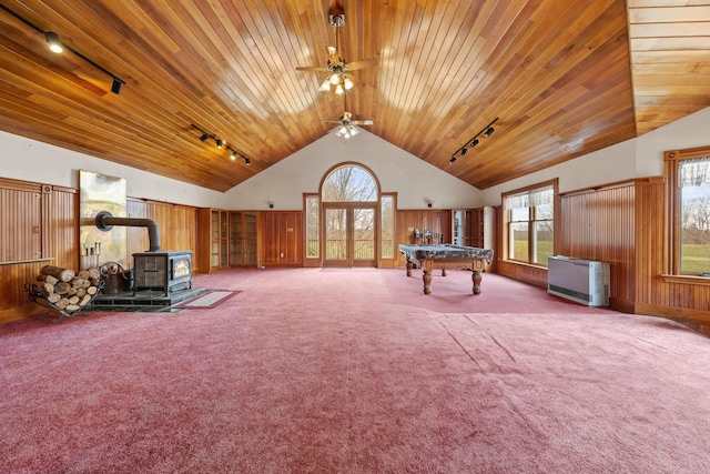 rec room with a wood stove, rail lighting, carpet, a ceiling fan, and pool table