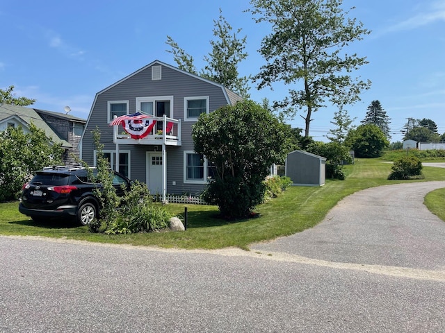 dutch colonial with a front yard and a gambrel roof
