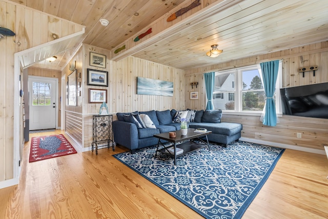 living room with wood finished floors, wooden walls, and wood ceiling