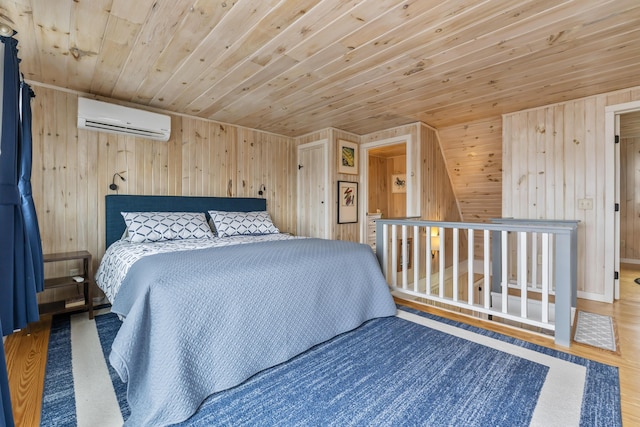bedroom with wood walls, wood finished floors, a wall mounted air conditioner, and wooden ceiling