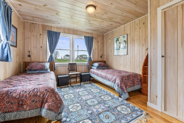 bedroom with wood walls, wood finished floors, and wood ceiling