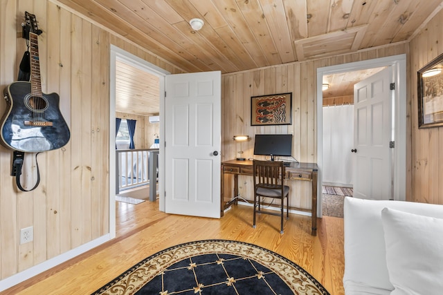 home office with wooden walls, wooden ceiling, and wood finished floors