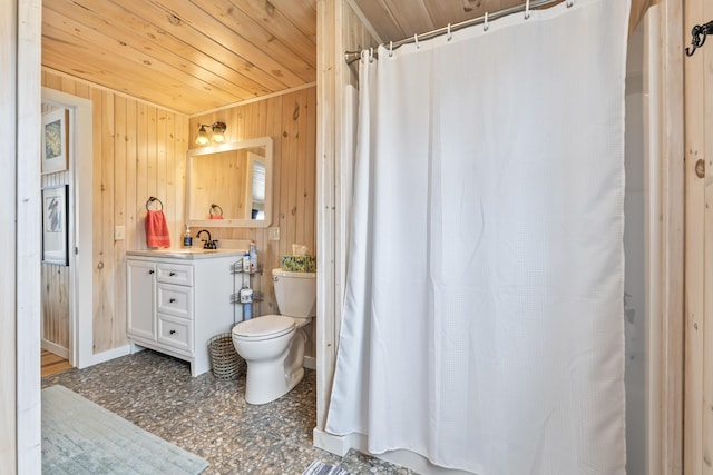 full bathroom featuring toilet, wooden ceiling, wood walls, and vanity