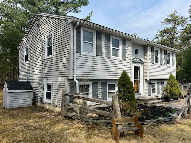 6 Northwood Cir, Hollis, ME 04042 - bi-level home featuring a storage unit and an outbuilding