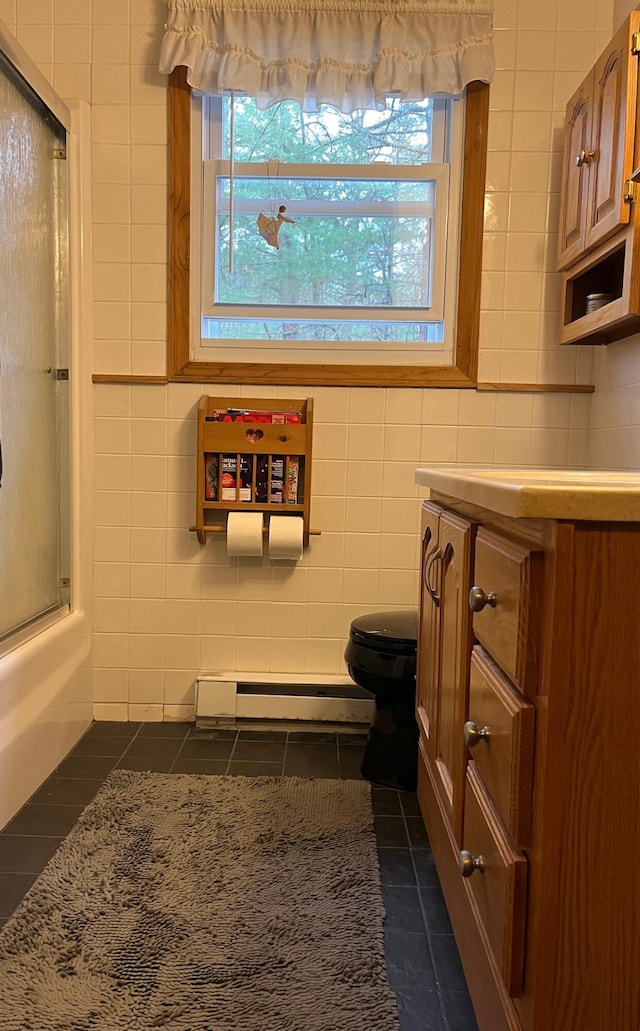 6 Northwood Cir, Hollis, ME 04042 - bathroom with tile walls, a healthy amount of sunlight, toilet, tile patterned flooring, and baseboard heating