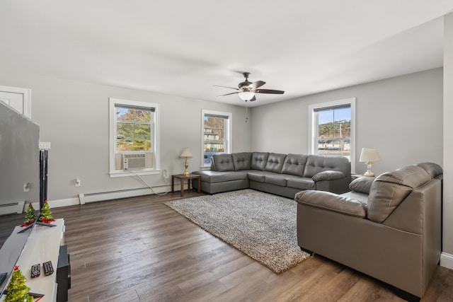 living area with a ceiling fan, wood finished floors, baseboards, a baseboard radiator, and cooling unit