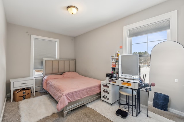 bedroom with carpet floors and baseboards