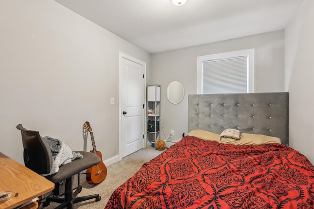 carpeted bedroom featuring baseboards