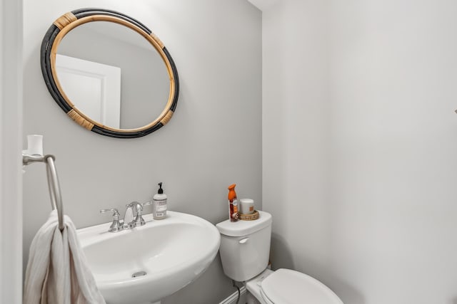 half bath featuring a sink and toilet