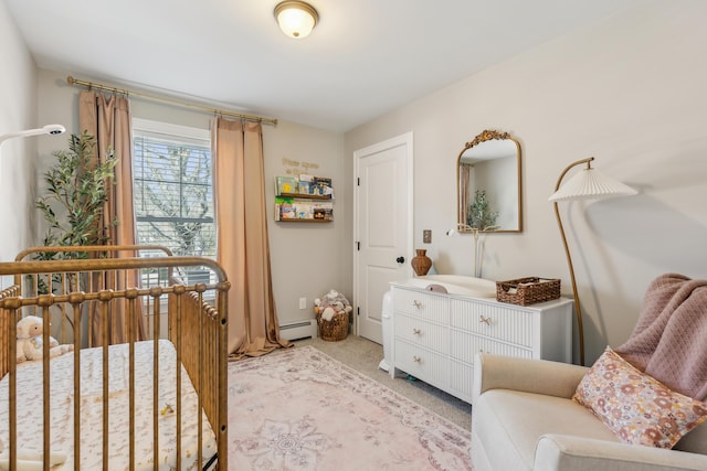 bedroom featuring a baseboard heating unit, light carpet, and a crib