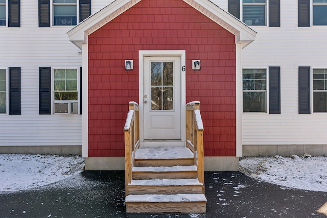 view of snow covered property entrance