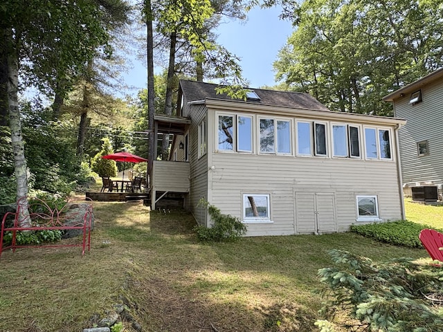 25-26 Mass Ave, Raymond, ME 04071 - view of side of home featuring a yard, a shingled roof, and a deck
