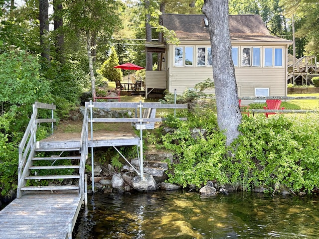 25-26 Mass Ave, Raymond, ME 04071 - rear view of house featuring a deck with water view, roof with shingles, and stairway