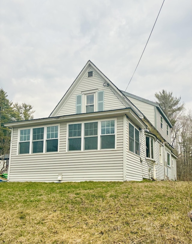view of property exterior featuring a lawn