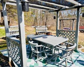 wooden deck with outdoor dining area and a pergola