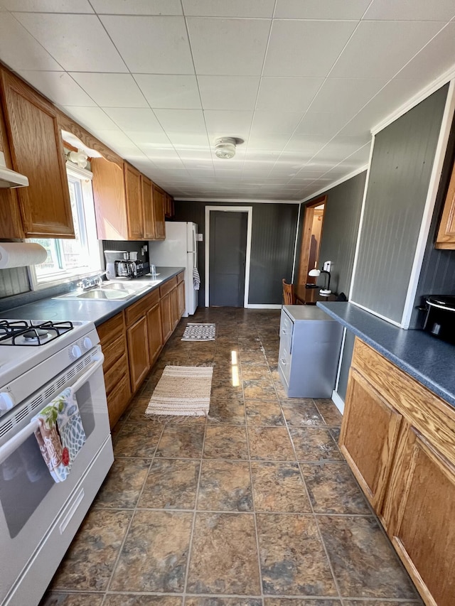 6 Lyons St, Machias, ME 04654 - kitchen with brown cabinetry, a sink, and white appliances
