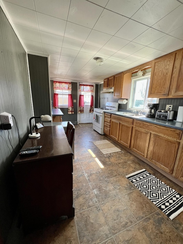 6 Lyons St, Machias, ME 04654 - kitchen featuring plenty of natural light, brown cabinetry, and white range with gas cooktop