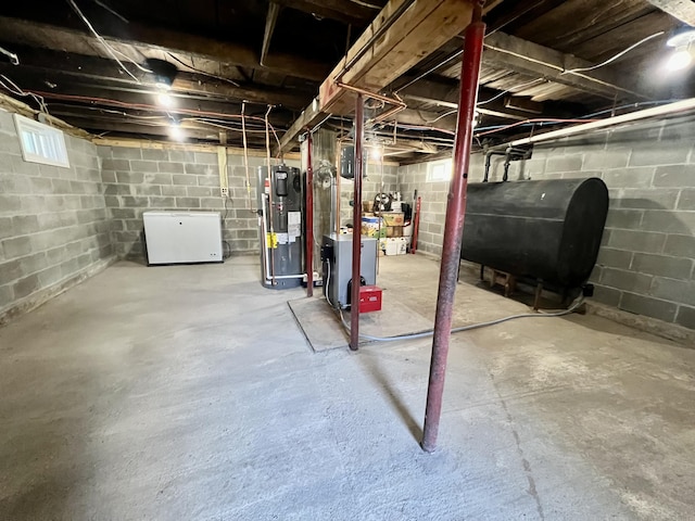 6 Lyons St, Machias, ME 04654 - below grade area with heating fuel, a heating unit, heat pump water heater, and fridge