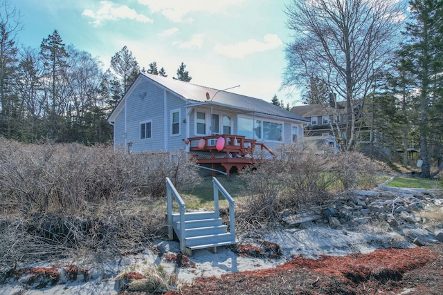 rear view of house featuring a deck