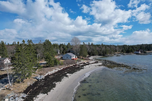 drone / aerial view featuring a water view and a forest view