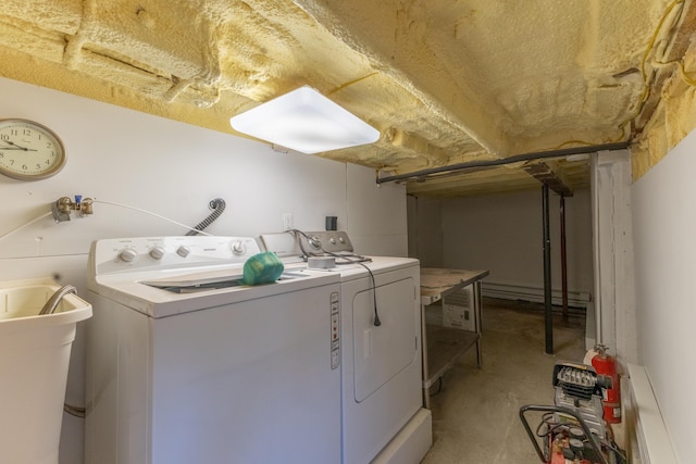 laundry room with a sink, laundry area, and independent washer and dryer