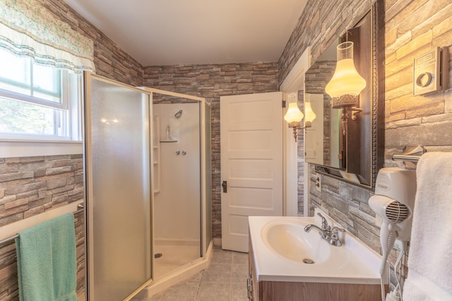 bathroom featuring vanity, a shower stall, and tile patterned floors