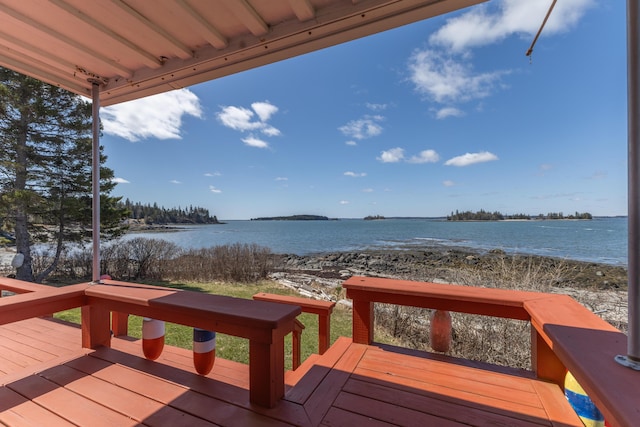 wooden terrace featuring a water view