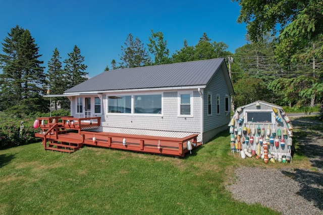 397 Cape Split Rd, Addison, ME 04606 - back of house featuring a lawn, a wooden deck, a metal roof, and an outdoor structure