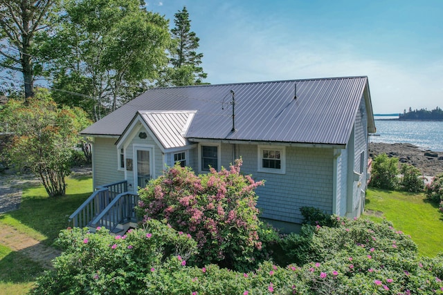 397 Cape Split Rd, Addison, ME 04606 - rear view of house featuring a yard, a metal roof, and a water view