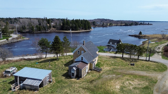 drone / aerial view with a water view and a view of trees