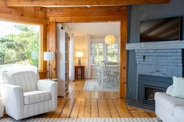 interior space with wooden walls, a fireplace, and hardwood / wood-style flooring
