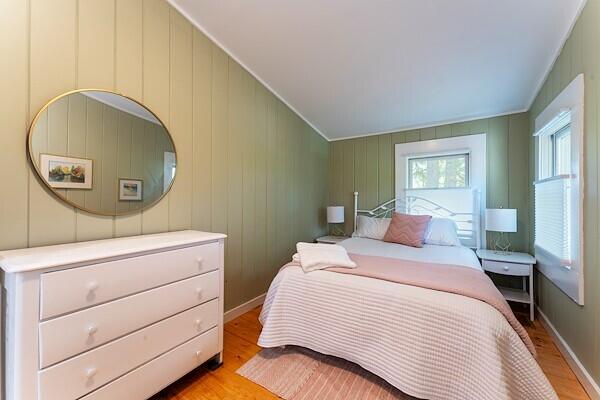 bedroom featuring baseboards and light wood-type flooring