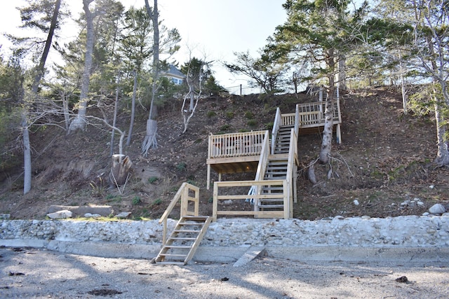 surrounding community with stairway and a deck