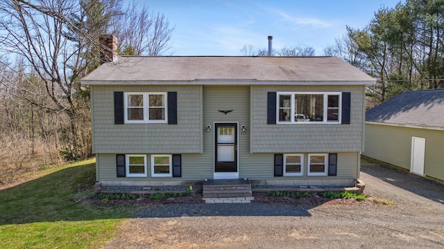 135 Williams Rd, Newport, ME 04953 - split foyer home featuring a chimney and a shingled roof