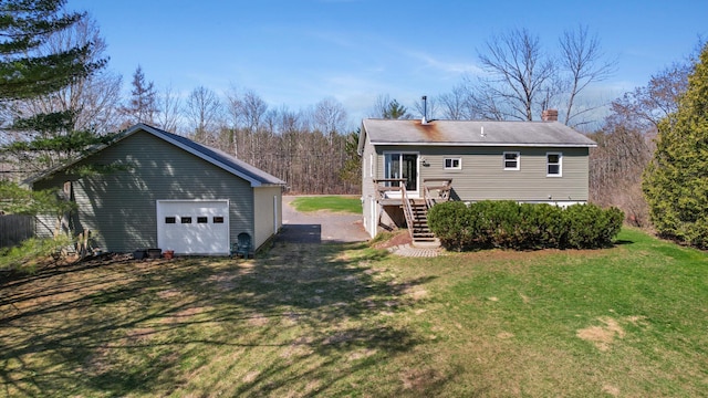 135 Williams Rd, Newport, ME 04953 - back of house featuring a yard, a detached garage, stairs, and an outbuilding