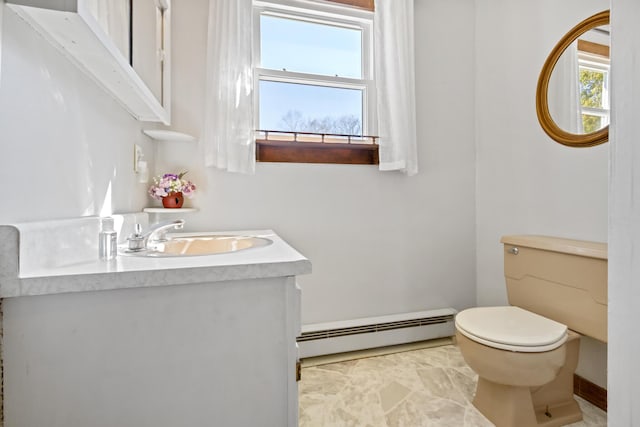 135 Williams Rd, Newport, ME 04953 - half bathroom with toilet, vanity, and a baseboard radiator