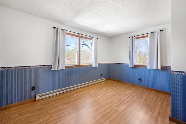 135 Williams Rd, Newport, ME 04953 - unfurnished room with plenty of natural light, a wainscoted wall, wood finished floors, and a baseboard radiator