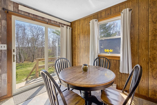 135 Williams Rd, Newport, ME 04953 - dining room with wood walls and a wealth of natural light