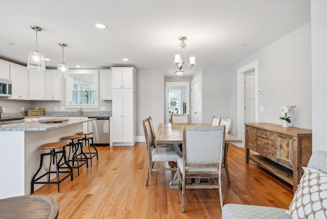 dining room featuring light wood-style floors, recessed lighting, and a chandelier