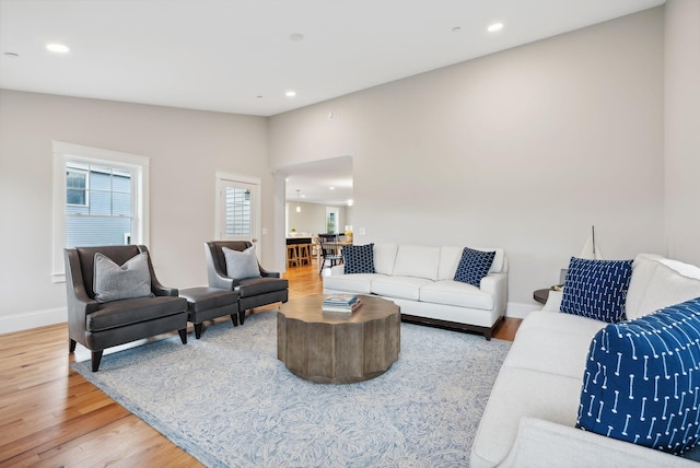 living room with recessed lighting, wood finished floors, and baseboards