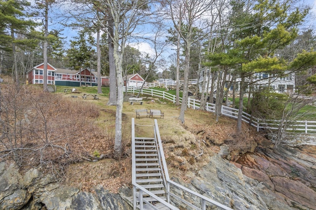 view of yard with stairway and fence